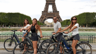 A family on bikes in front of the Eiffel Tower enjoying a Paris Electric Bike Tours activity