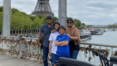 Pont des Arts pedestrian bridge with Eiffel Tower and a family enjoying a Paris bike tours for families
