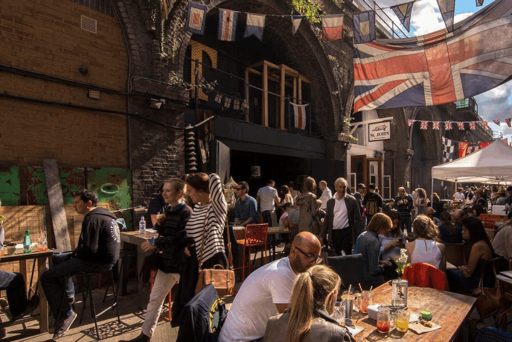 Inside Camden Market with table and food and drink on a London private tours activity