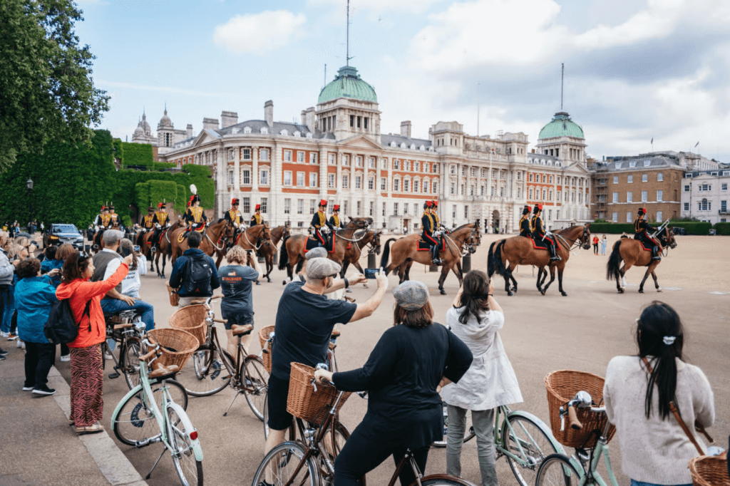 London bike tour guide stopping with cyclists to watch the Horse Guards parade at Horse Guards Parade in London