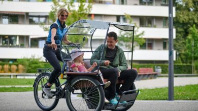 Family enjoying a cargo bike ride with child seating, showcasing family-friendly options for munich bike rental in the city.